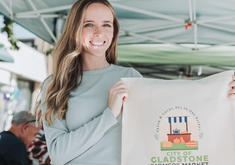 Downtown Ambassador holding Farmers Market Canvas Bag Swag
